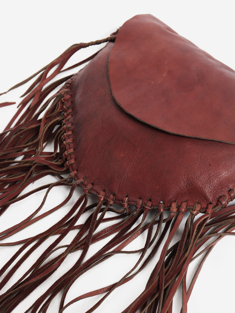 Pinkish brown leather tassel clutch bag
