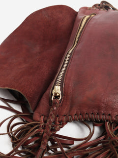 Pinkish brown leather tassel clutch bag