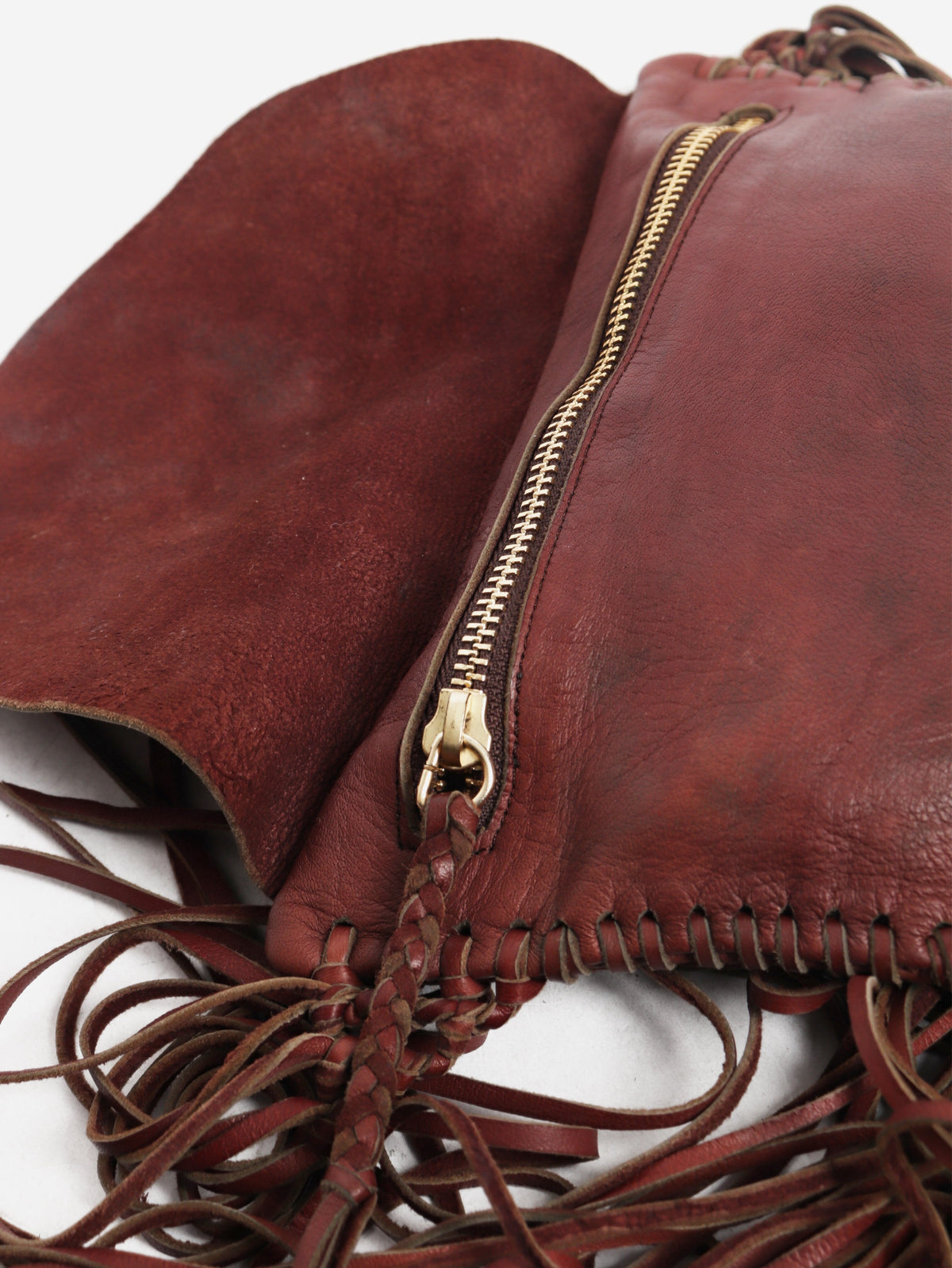 Pinkish brown leather tassel clutch bag