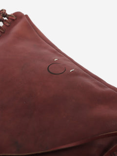 Pinkish brown leather tassel clutch bag