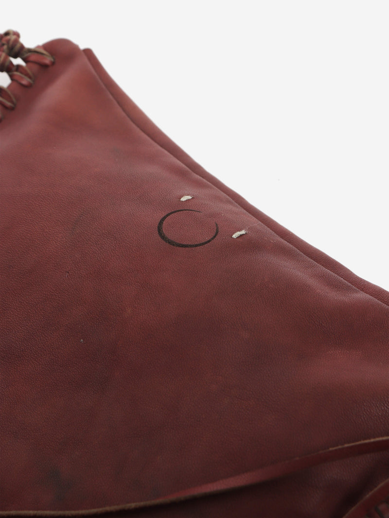 Pinkish brown leather tassel clutch bag