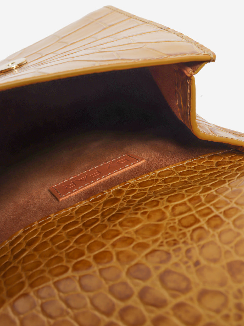 Mustard croc-embossed leather clutch bag